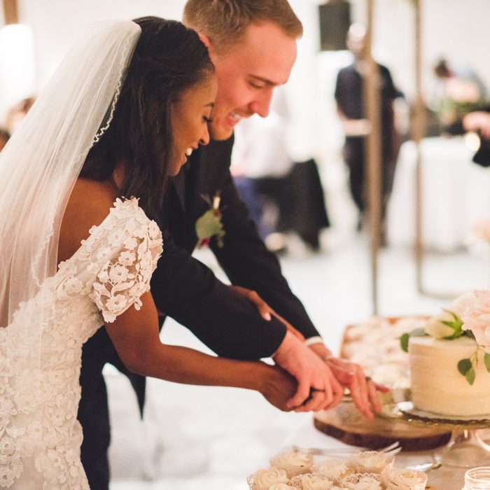 happy atlanta bride and groom cutting cake